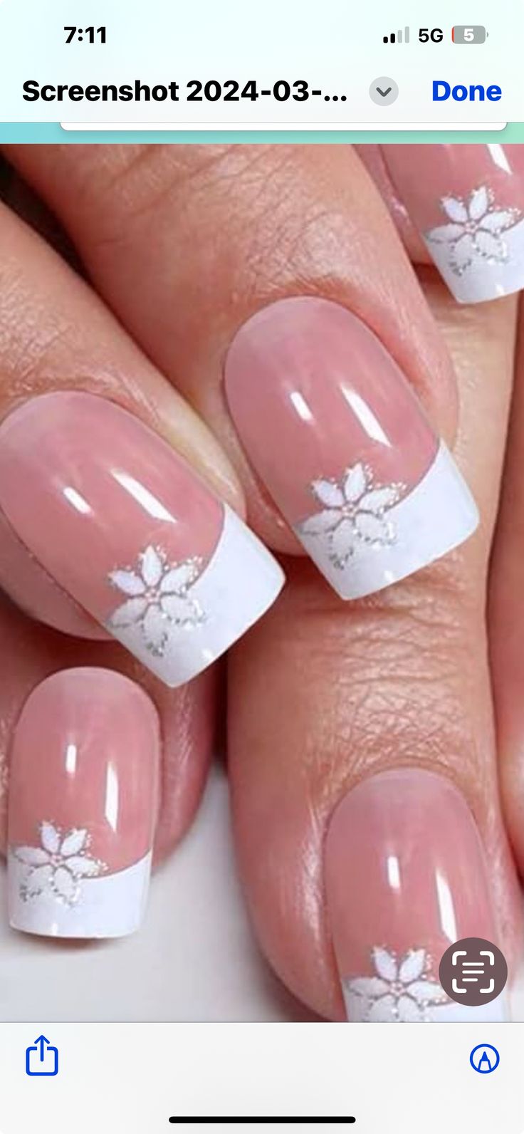 Elegant French Tip Nail Design with Soft Pink Base and Floral Embellishments