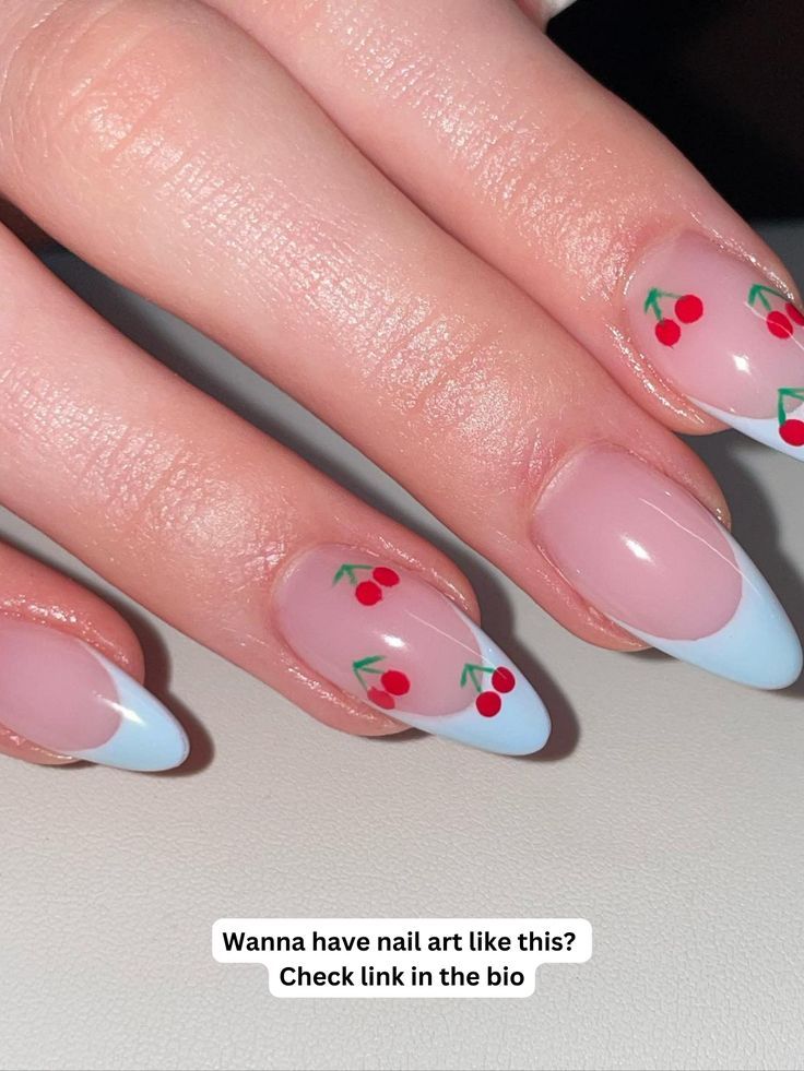 Charming Cherry Blossom Nail Design: Soft Pink Base with Playful Blue Tips and Delicate Red Motifs.