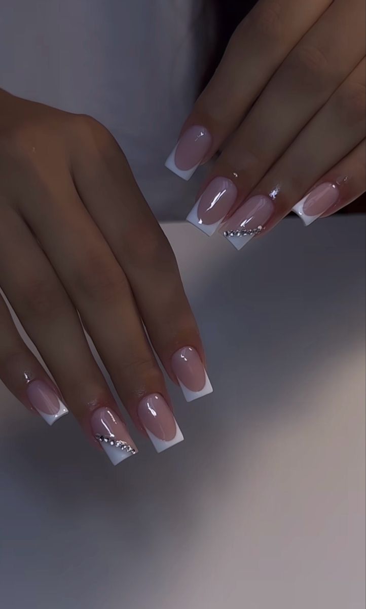 Sophisticated French Manicure with Modern Embellishments: Perfect for Any Occasion.