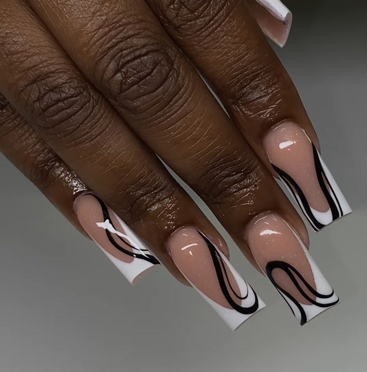 Modern Elegant Nail Design: Nude Base with Bold Black and White Swirls.