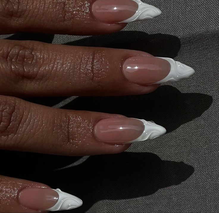 Chic Nude Base with Dramatic Pointed White Tips: A Modern Twist on French Manicure.