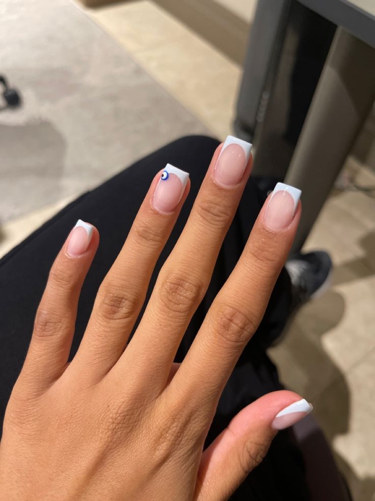 Elegant French Manicure with Modern Twist and Unique Accent.