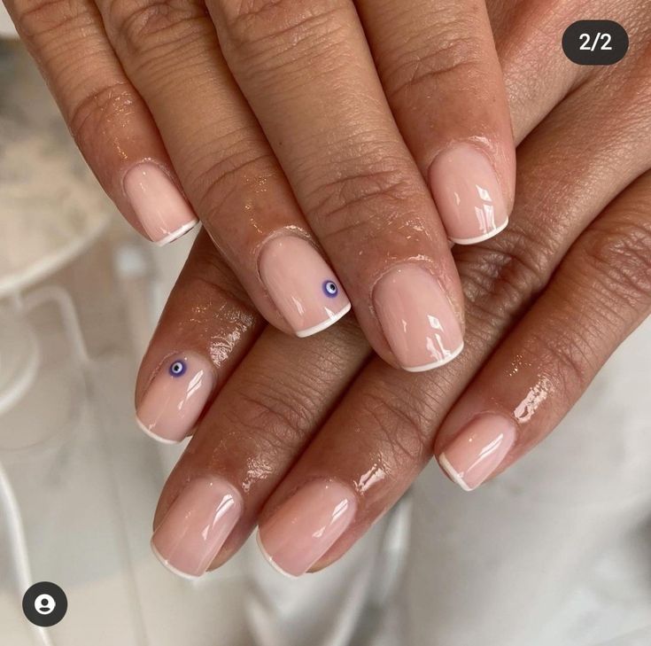 Sophisticated Elegant Nude Nail Design with Classic French Tips and Soft Pastel Accents.