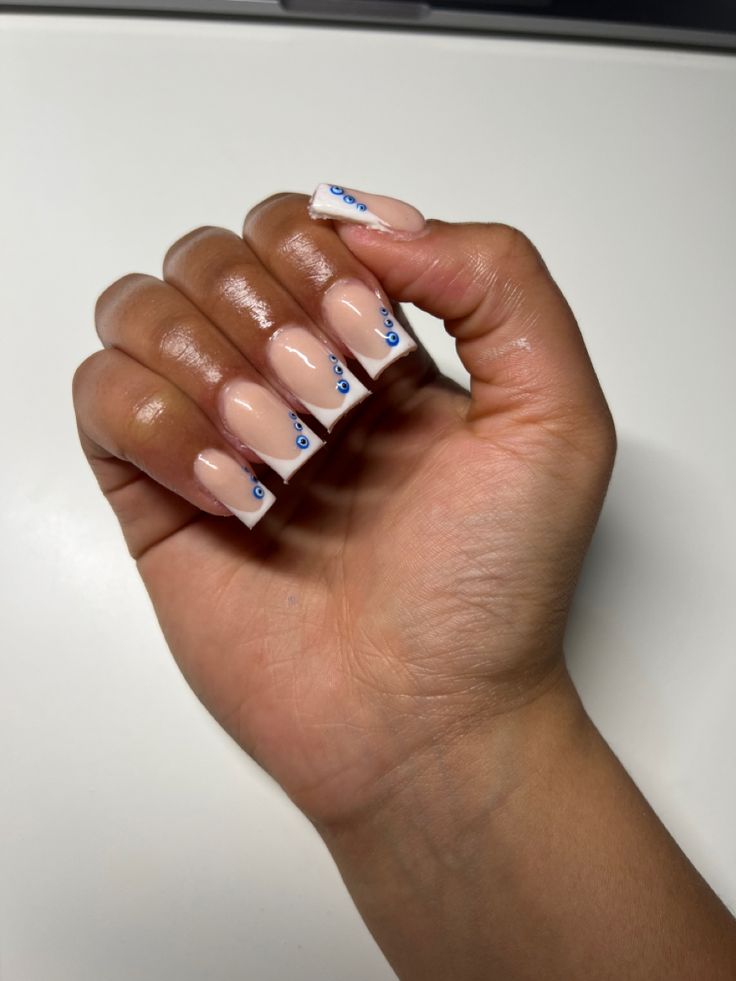 Chic Nude Nail Design with Delicate Blue Dot Accents