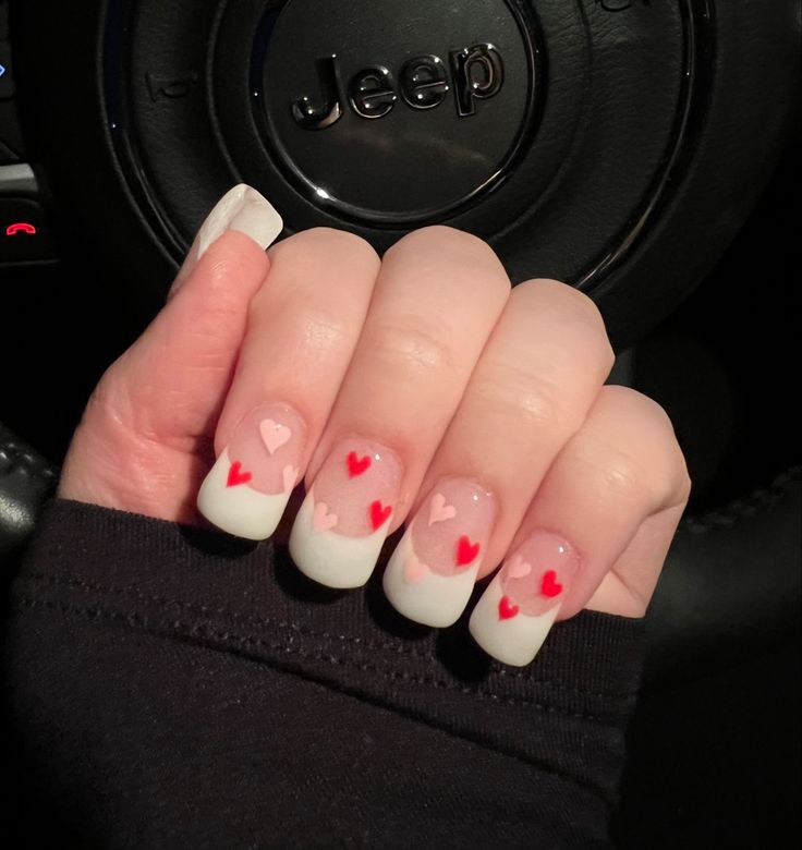 Chic French Manicure with Playful Heart Accents in Pink and Red