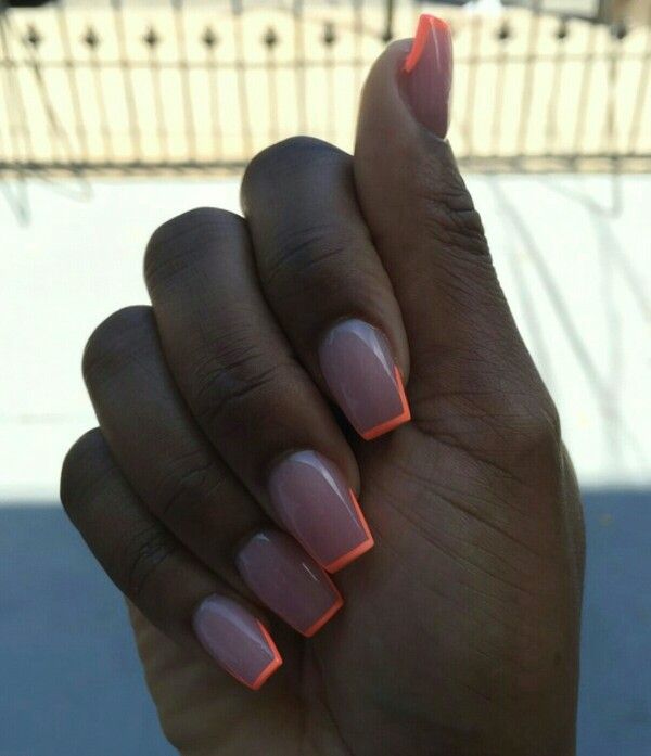 Chic Nude Nails with Striking Neon Orange Tips for a Modern Statement Look.