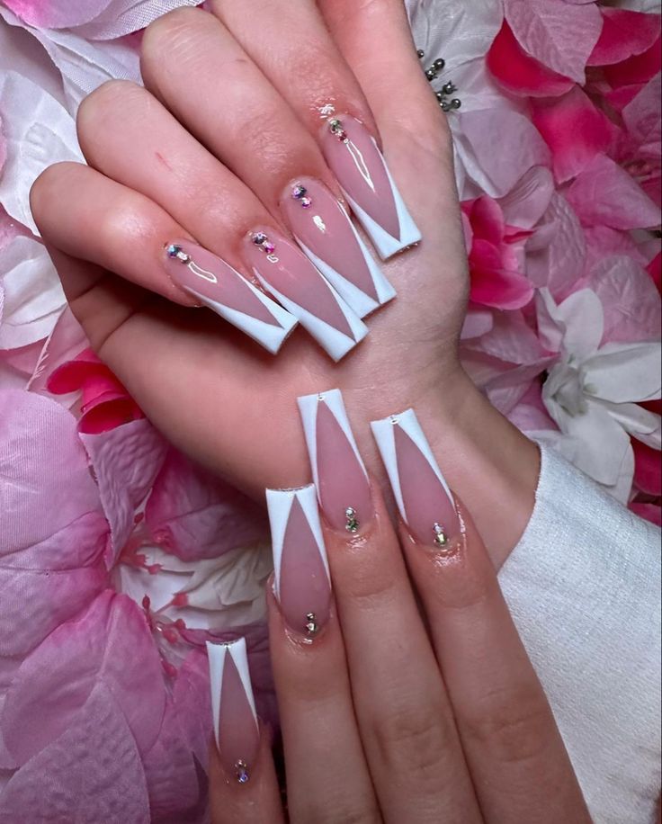 Chic Elegant Nail Design with Nude and White Tips, Sparkling Accents, and Geometric Patterns.