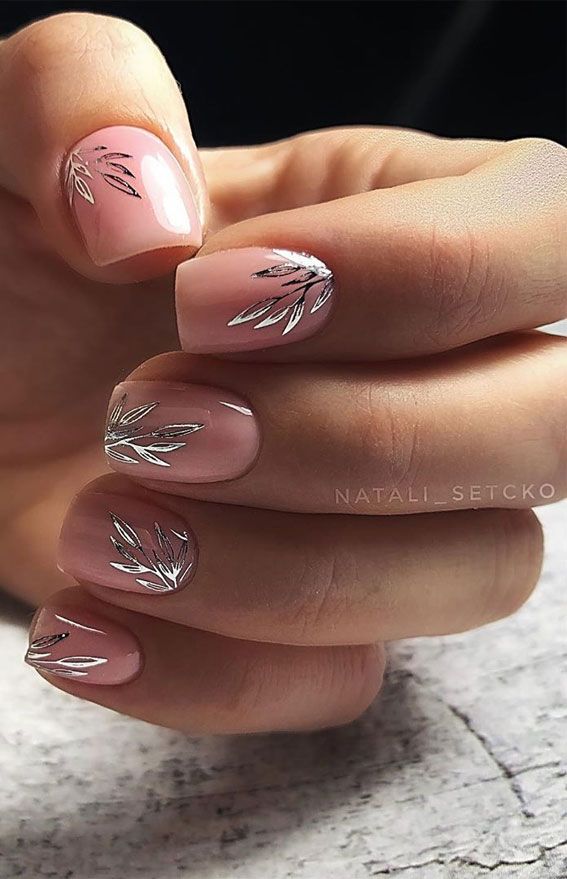 Sophisticated Nude Pink Nail Design with Delicate Silver Leaf Accents