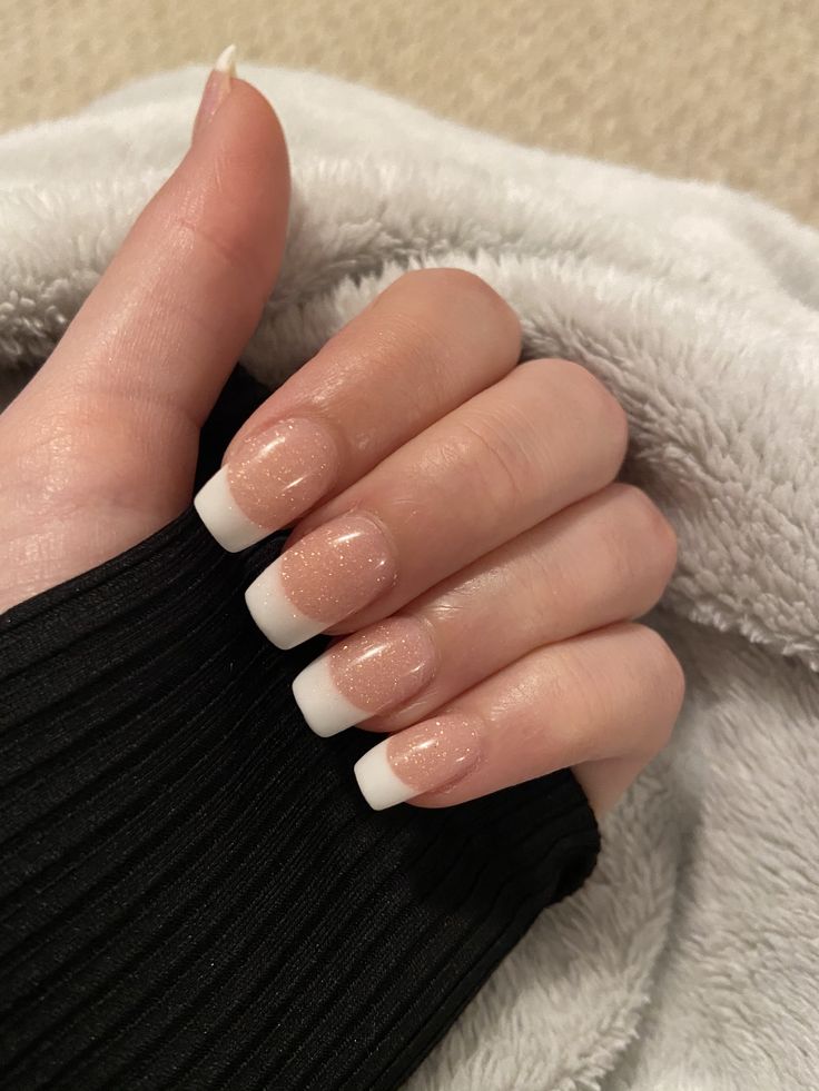 Refined Elegant French Tip Nails with Shimmering Nude Base and Sparkle.