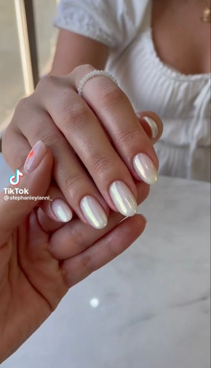 Elegant Translucent Nail Design with Iridescent Finish and Subtle Accent Color.