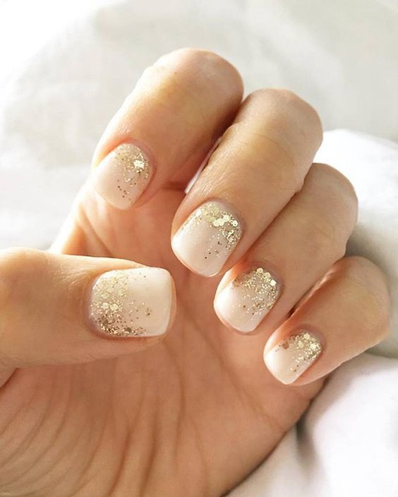 Nude Nail Design with Shimmering Gold Glitter Gradient for Chic Elegance.