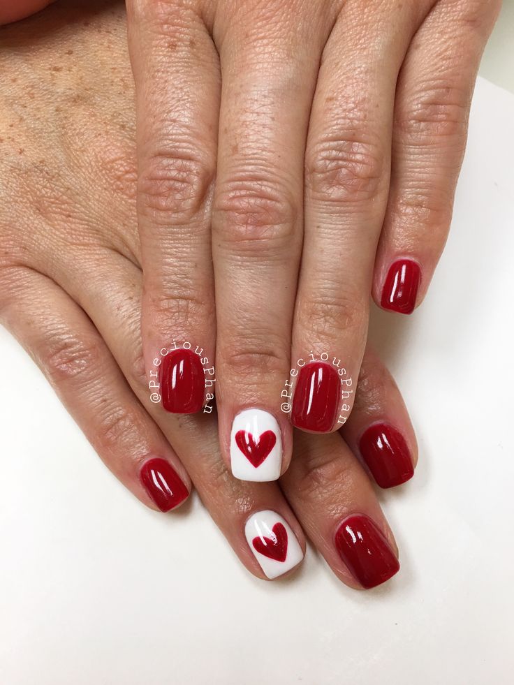 Romantic Red and White Nail Design with Heart Motif for Special Occasions.