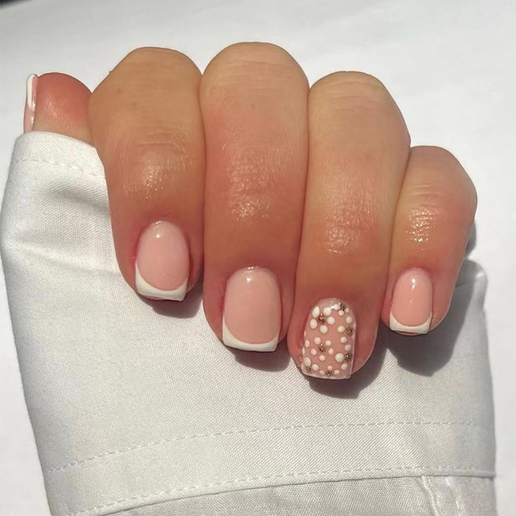 Elegant Nude Nail Design with Classic French Tips and Textured White Dots.