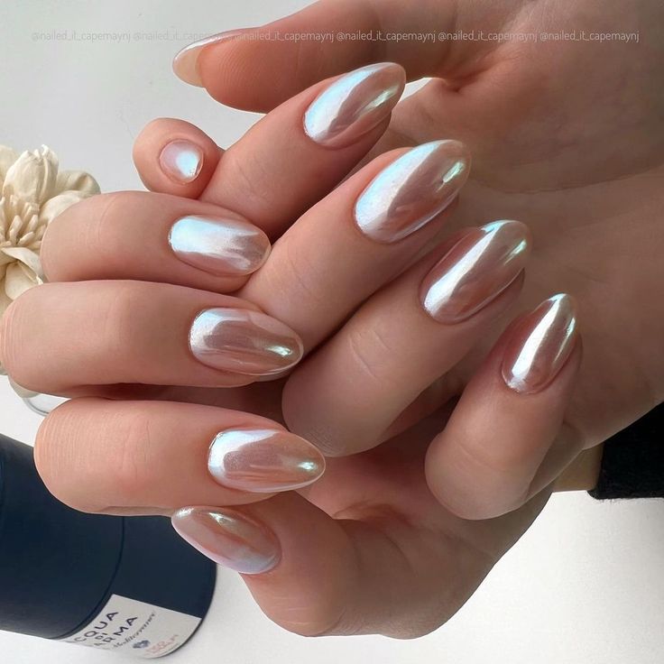 Elegant Iridescent Almond Nail Design in Soft Pink and Shimmering White.