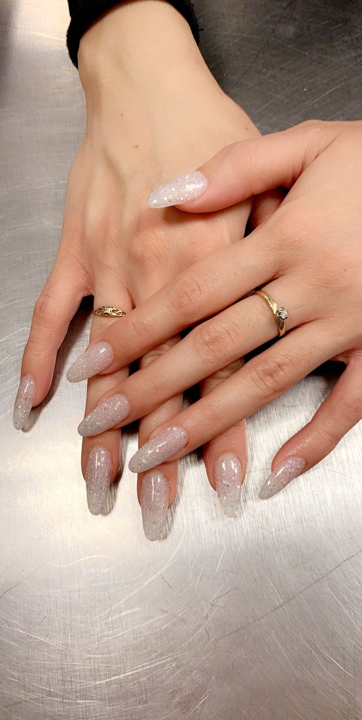 Sophisticated Long Tapered Nail Design with Soft White Gradient and Shimmering Glitter