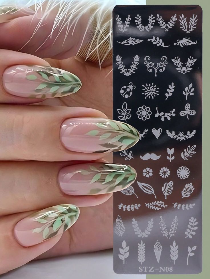 Sophisticated Floral Nail Design with Nude Base and Elegant Green Leaf Patterns.