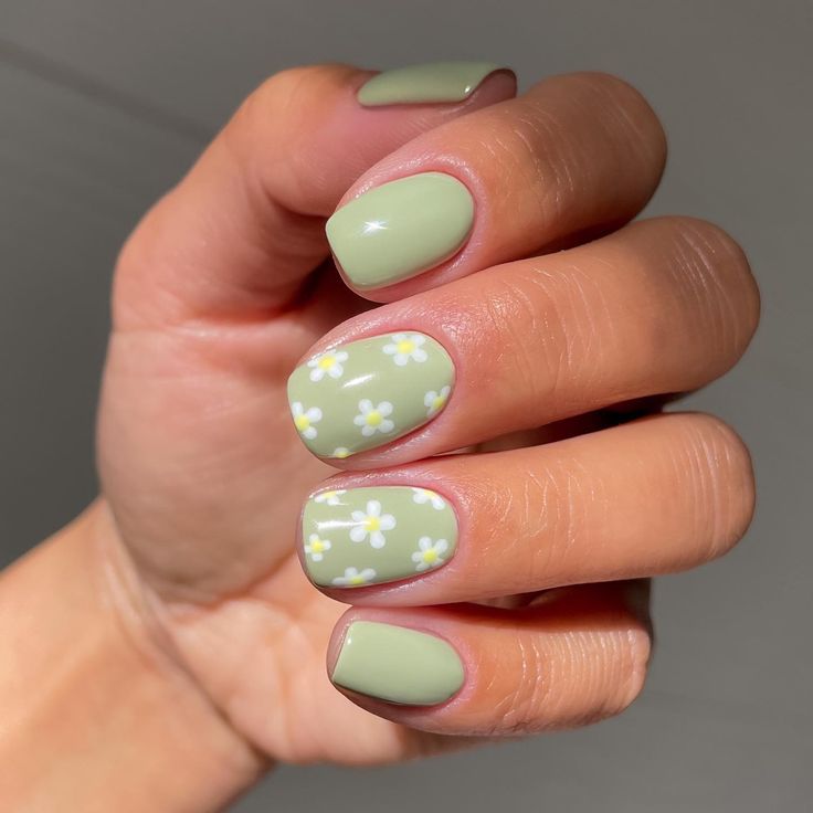 Charming Fresh Green Nail Design: Soft Matte Mint Base with Delicate White Floral Accents for Spring Elegance.