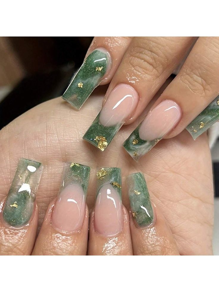 Sophisticated Nail Design: Translucent Green and Soft Nude with Luxurious Gold Flakes.