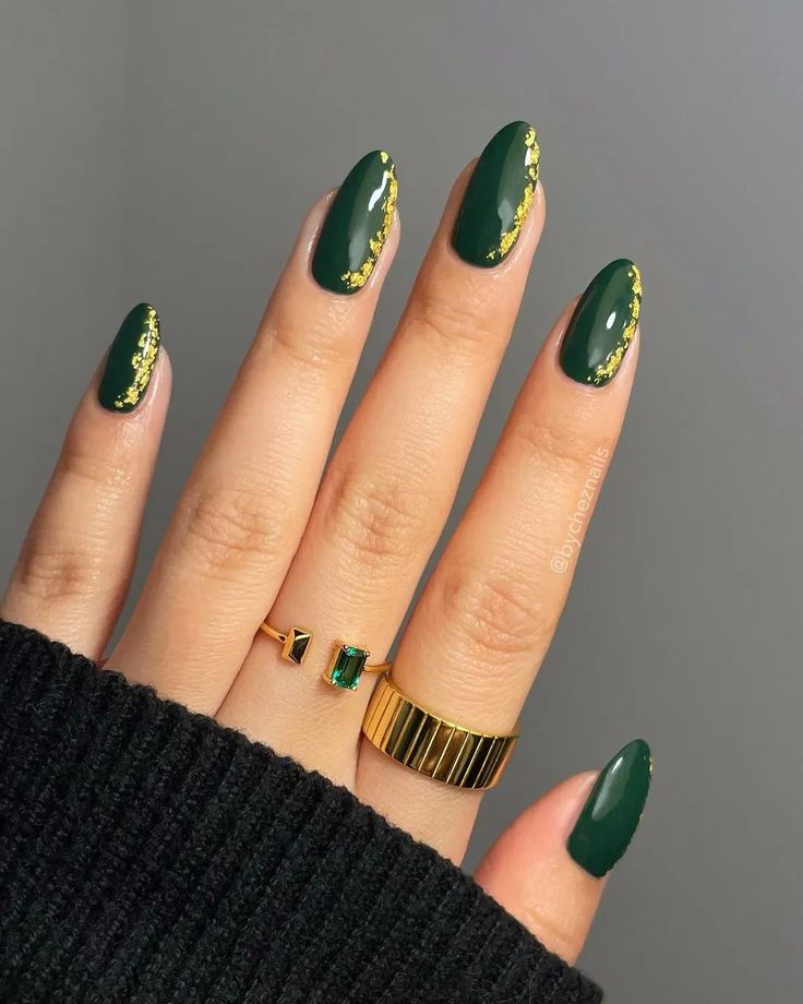 Sophisticated Dark Green Almond Nails with Glossy Finish and Gold Foil Accents.