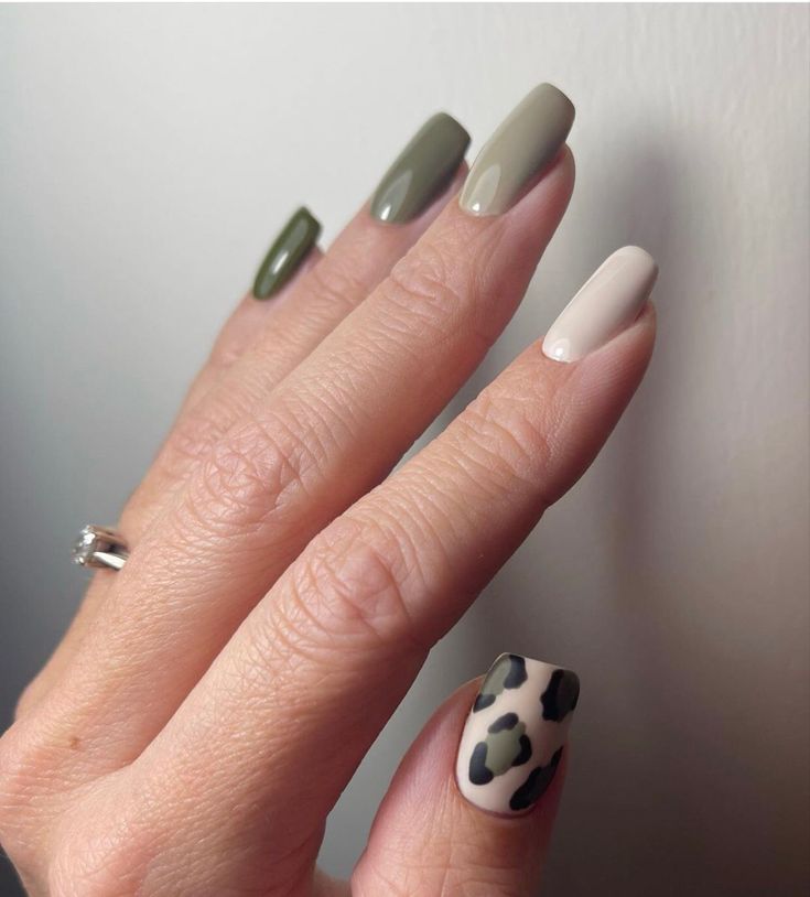 Chic Green Nail Design with Leopard Print Accent for a Stylish Touch.