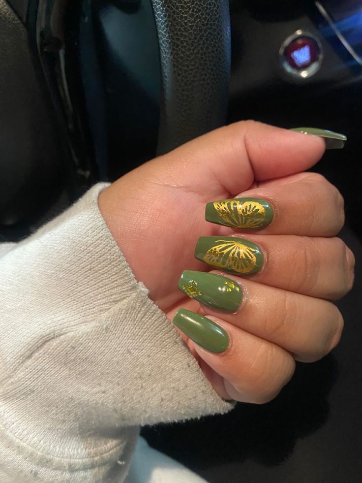 Sophisticated Green Nail Art with Glossy Finish and Intricate Gold Accents