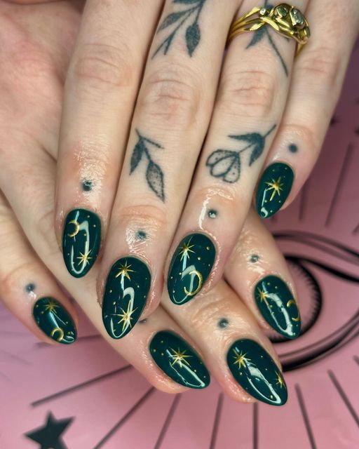 Celestial Elegance: Deep Green Nail Design with Gold Accents and Swirling Patterns