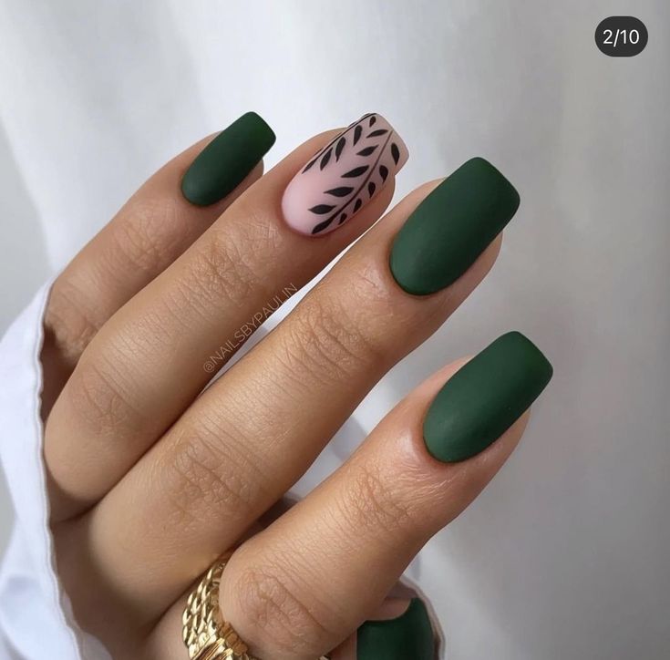 Sophisticated Matte Green Nail Design with Delicate Pink Accent and Black Leaf Patterns.