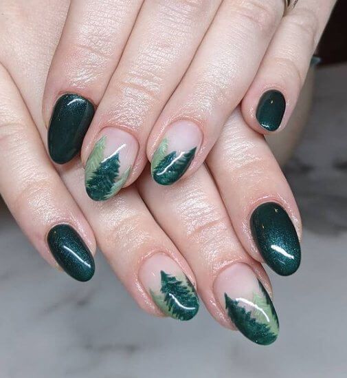 Elegant Nature-Inspired Nail Design with Deep Green Shades and Leaf Patterns.