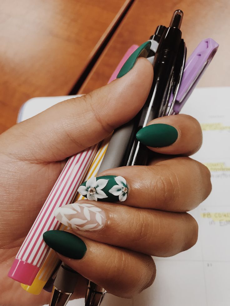 Chic Matte Green Nail Design with Floral Accents for Versatile Elegance.