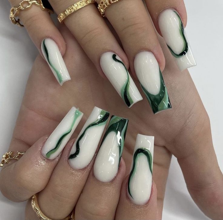 Elegant Long Nails with Striking White and Deep Green Swirling Design.