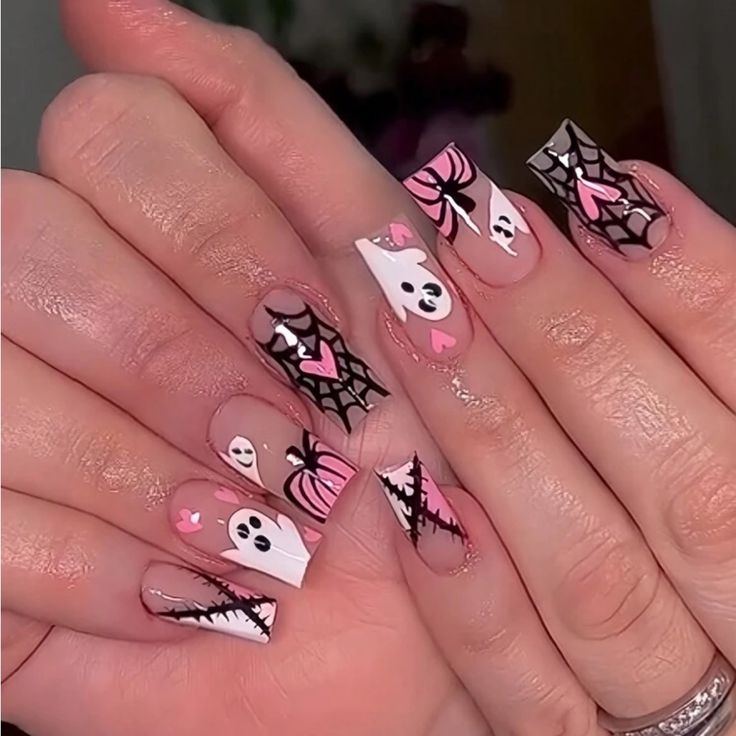 Whimsical Halloween Nail Design with Ghosts, Pumpkins, and Festive Heart Accents.