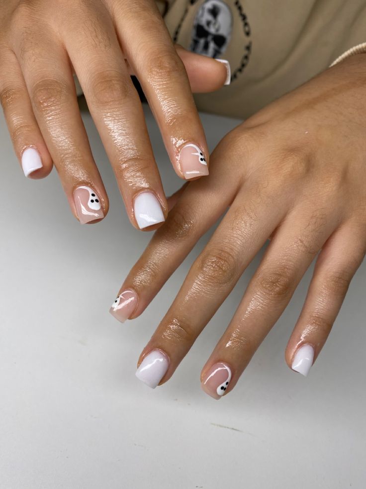 Elegant Nail Design with Soft Pink and White Hues Featuring Playful Black Dots and Abstract Shapes.