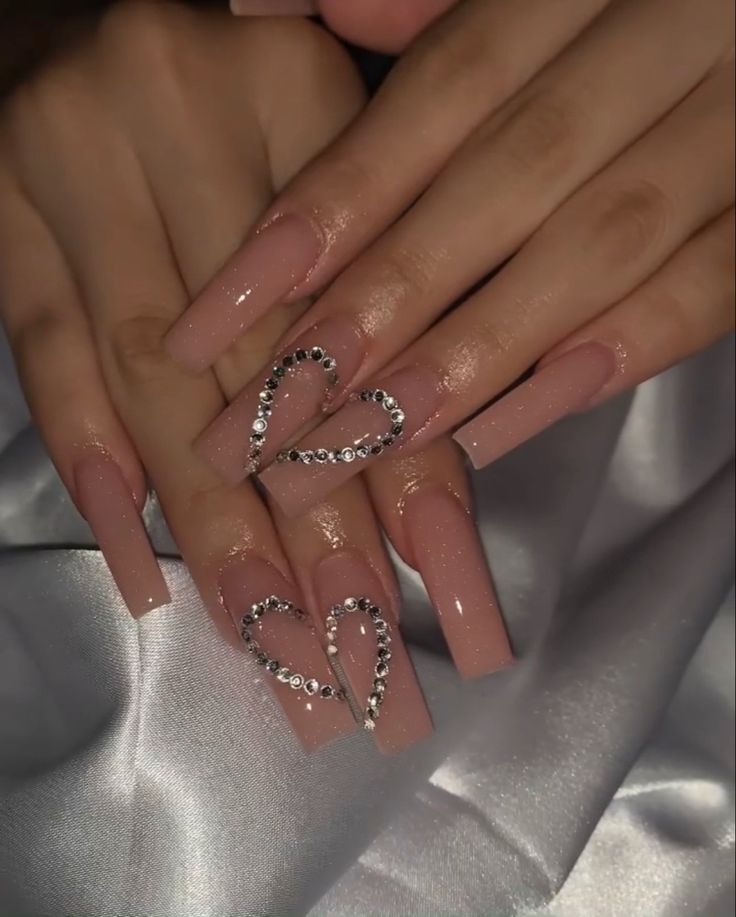 Glamorous Nude Nail Design with Rhinestone Heart Accents