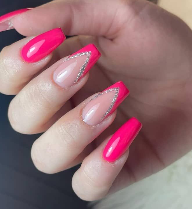 Bold Pink Nails with Elegant Chevron and Silver Accents for a Trendy Look.