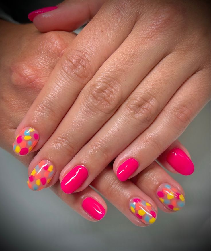 Bold Pink Nail Design with Playful Polka Dots and Pastel Accents for a Fun Look.