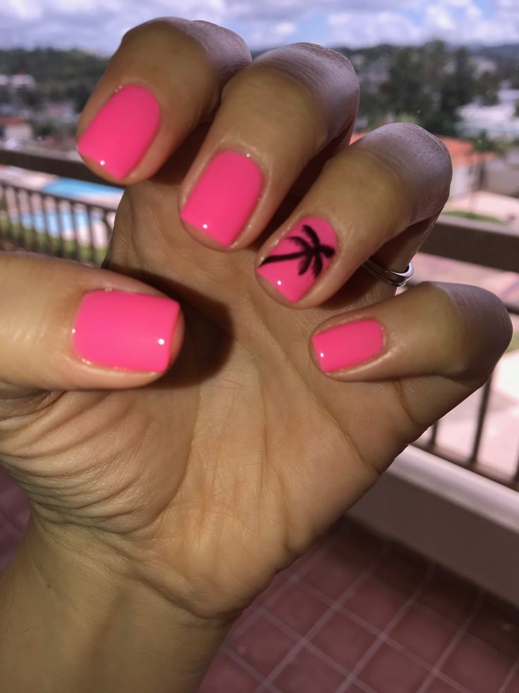 Vibrant Pink Manicure with Glossy Finish and Tropical Palm Tree Design for Summer Vibes.