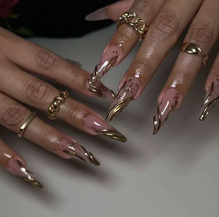 Luxurious Almond-Shaped Nail Design with Glossy Nude Base and Gold Accents