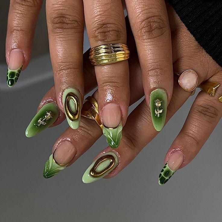 Bold and Elegant Green Nail Design with Avocado Patterns and Gold Accents.