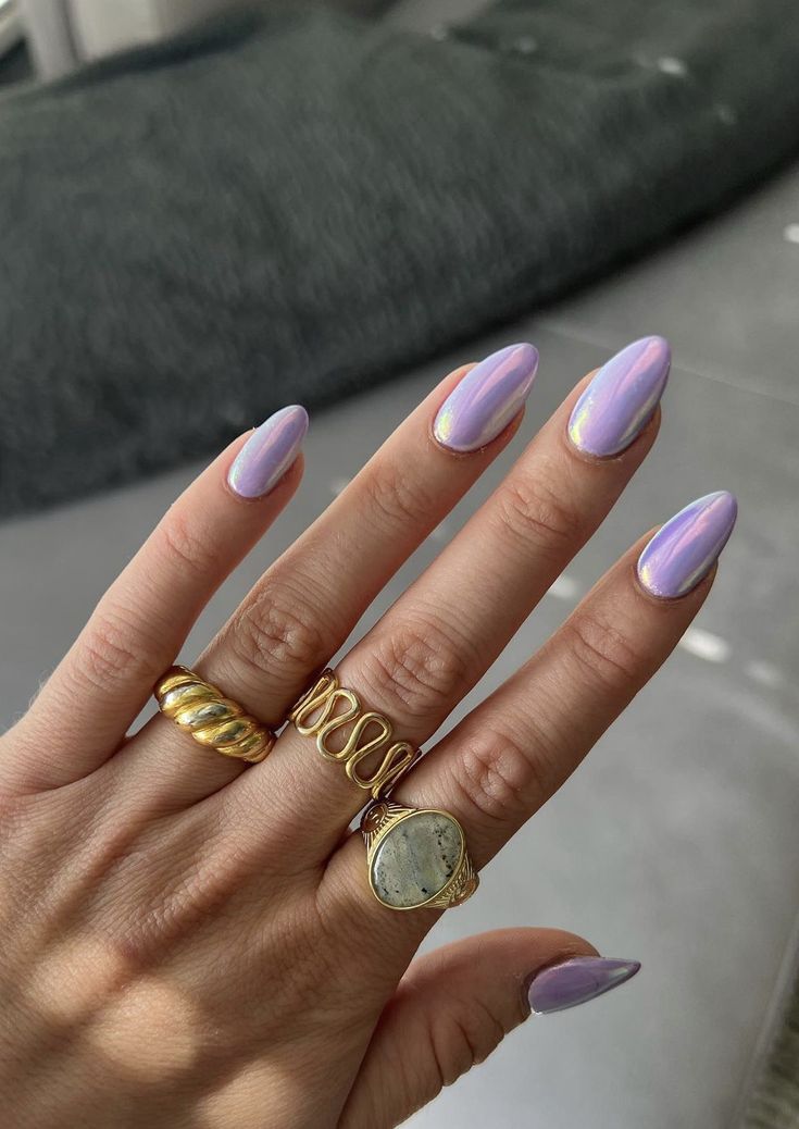 Elegant Lavender Nails: A Trendy Glossy Manicure with Subtle Shimmer and Gold Accents.