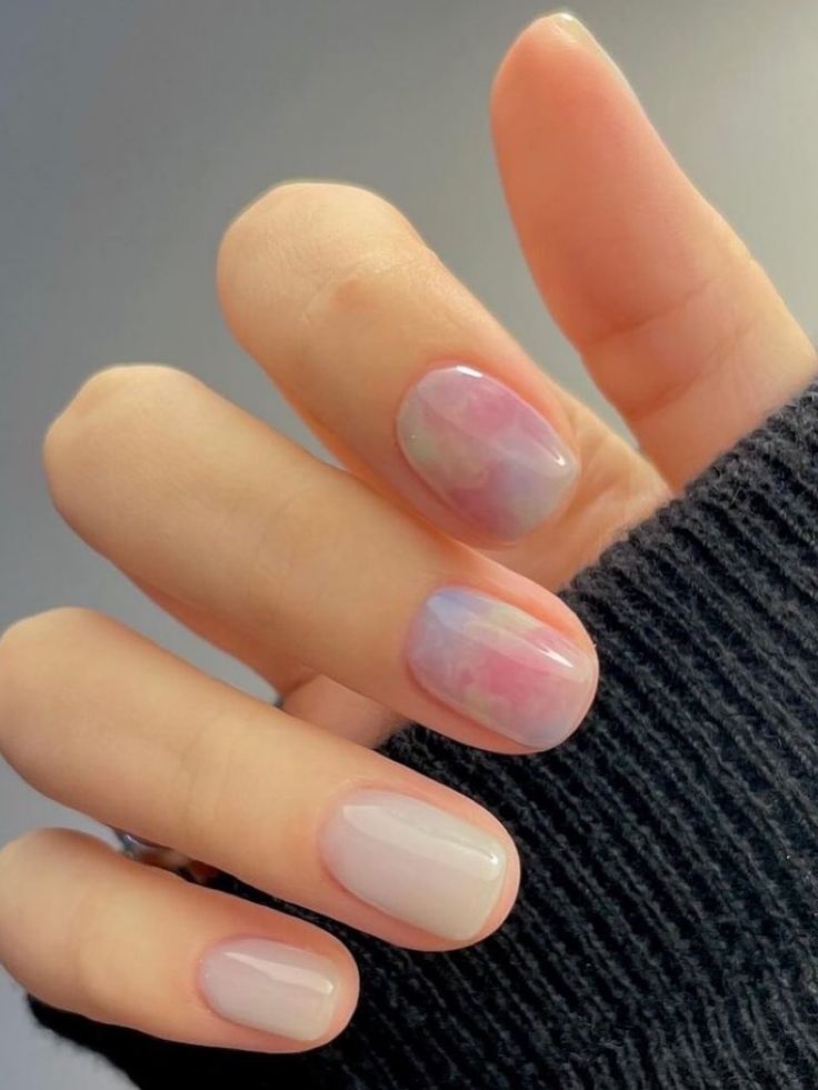 Elegant Pastel Nail Design: Translucent Accent with Pink, Blue, and Lavender Hues.