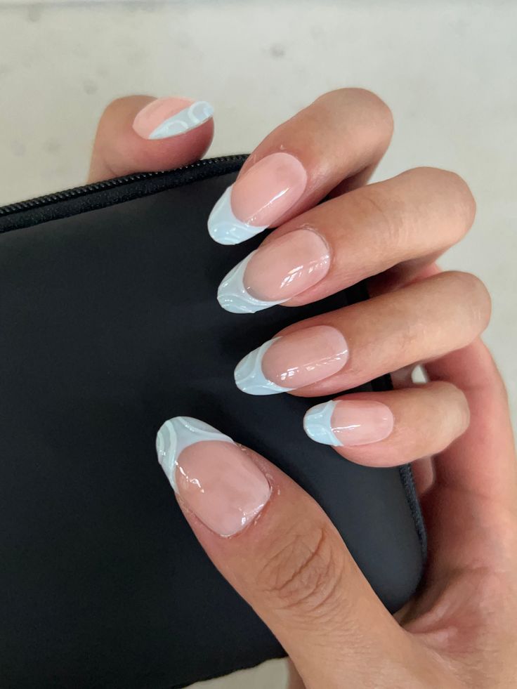 Chic and Playful: Modern French Manicure with Soft Nude Base and Pastel Blue Tips.