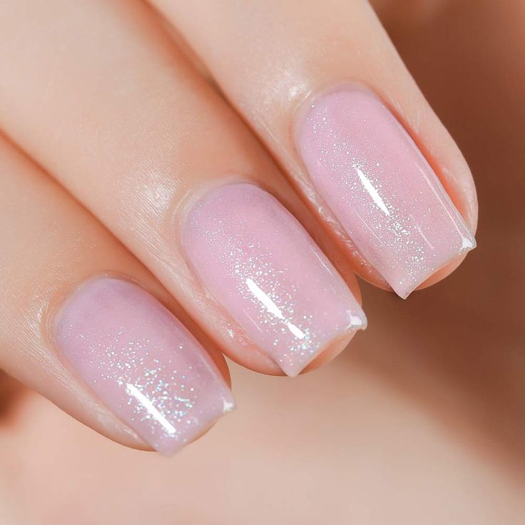 Chic Ombre Nails: Soft Pink Shades with Glitter Accents for Any Occasion.