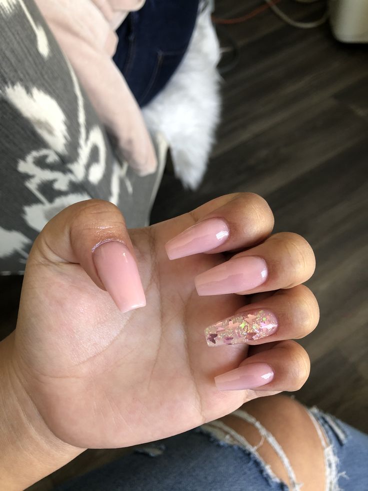 Chic Minimalist Nail Design with Soft Pink Base and Glamorous Gold Flakes Accent.