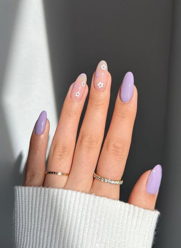 Elegant Lavender Nail Design with Floral Accents and Stylish Rings