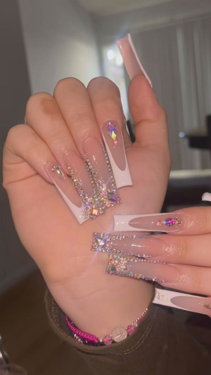 Elegant Long Nails Featuring Glossy White Tips and Sparkling Rhinestone Designs.