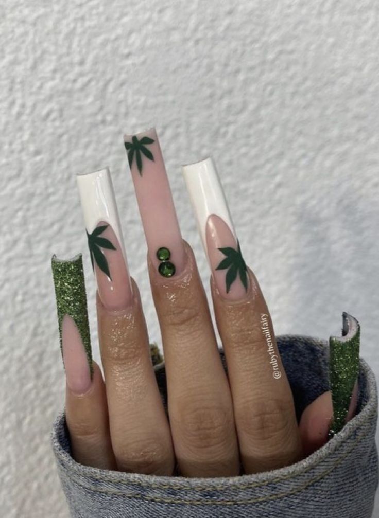 Tropical-Inspired Bold Nail Design with Glossy White and Nude Tips, Green Palm Patterns, and Glitter Accents.