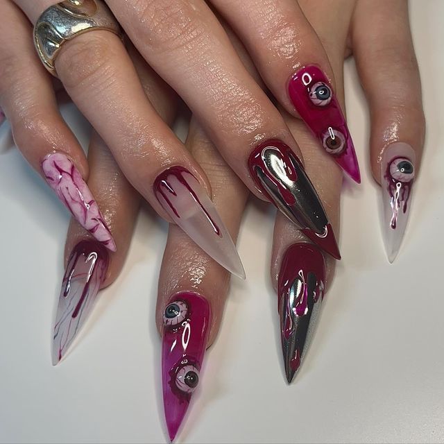 Bold Nail Art with Edgy Elongated Tips and Vibrant Drip Effect