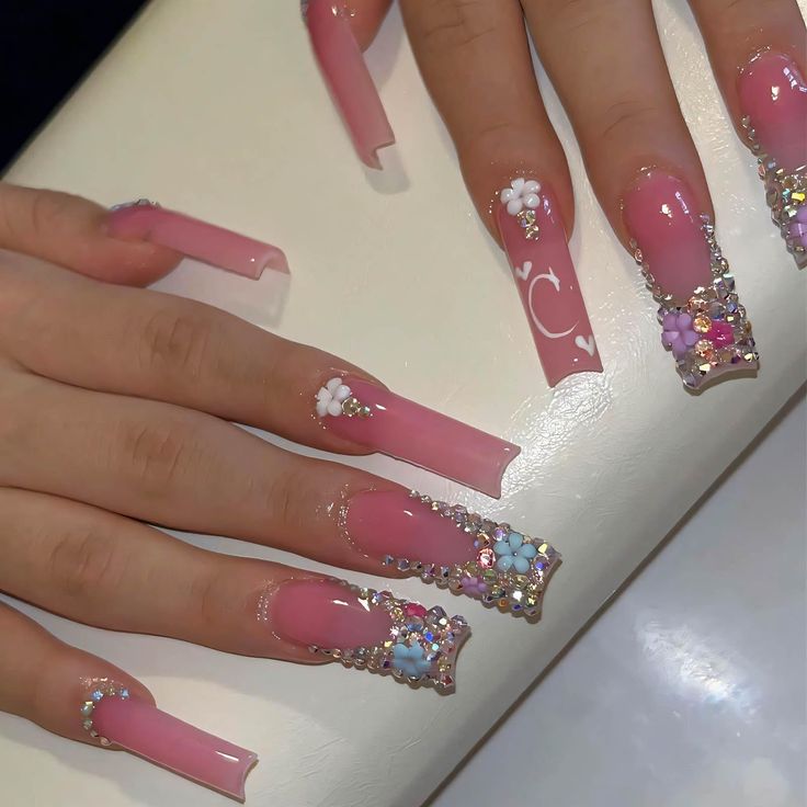 Glamorous Elegant Pink Stiletto Nails with Floral Embellishments and Rhinestone Accents