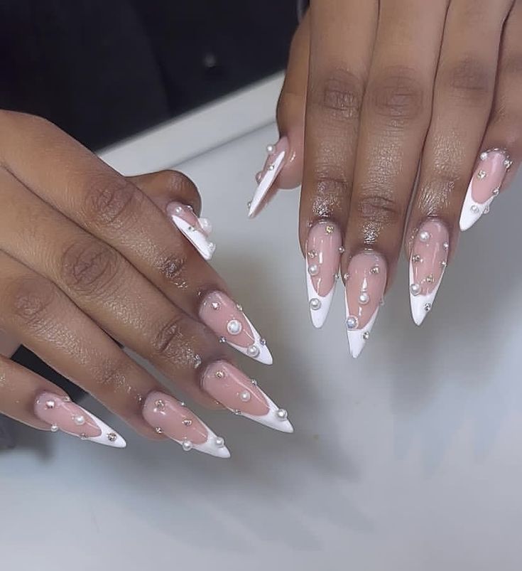 Chic Elegant Nail Design with Elongated Tips, Soft Pink Base, White Tips, and Delicate Pearls.