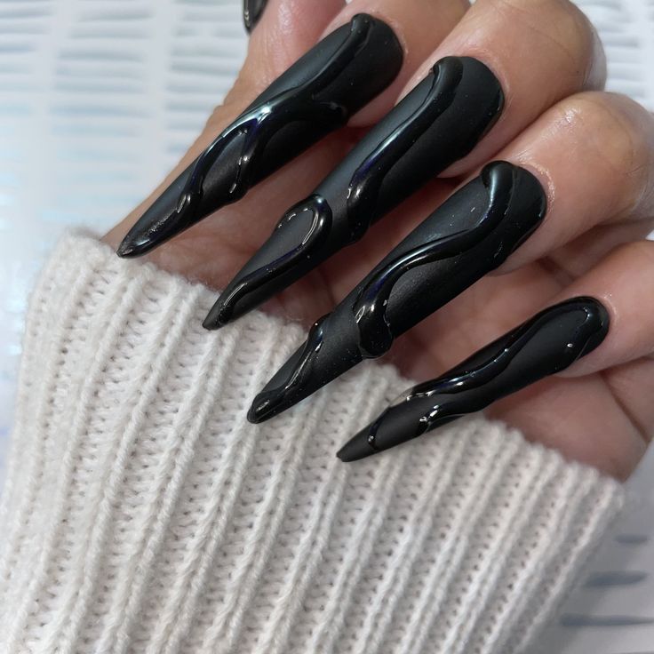 Bold Black Nail Design with Elongated Tips and Glossy Sculptural Texture